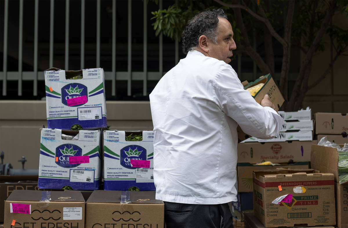 Chef Carlos Guia, executive chef at ARIA, unloads food donated by MGM Resorts outside the Las V ...