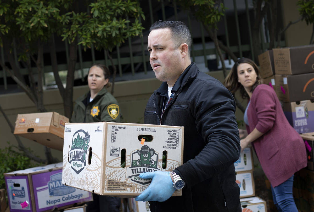 Officer Marc Viskoc helps stage a food donation from MGM Resorts outside the Las Vegas Metropol ...