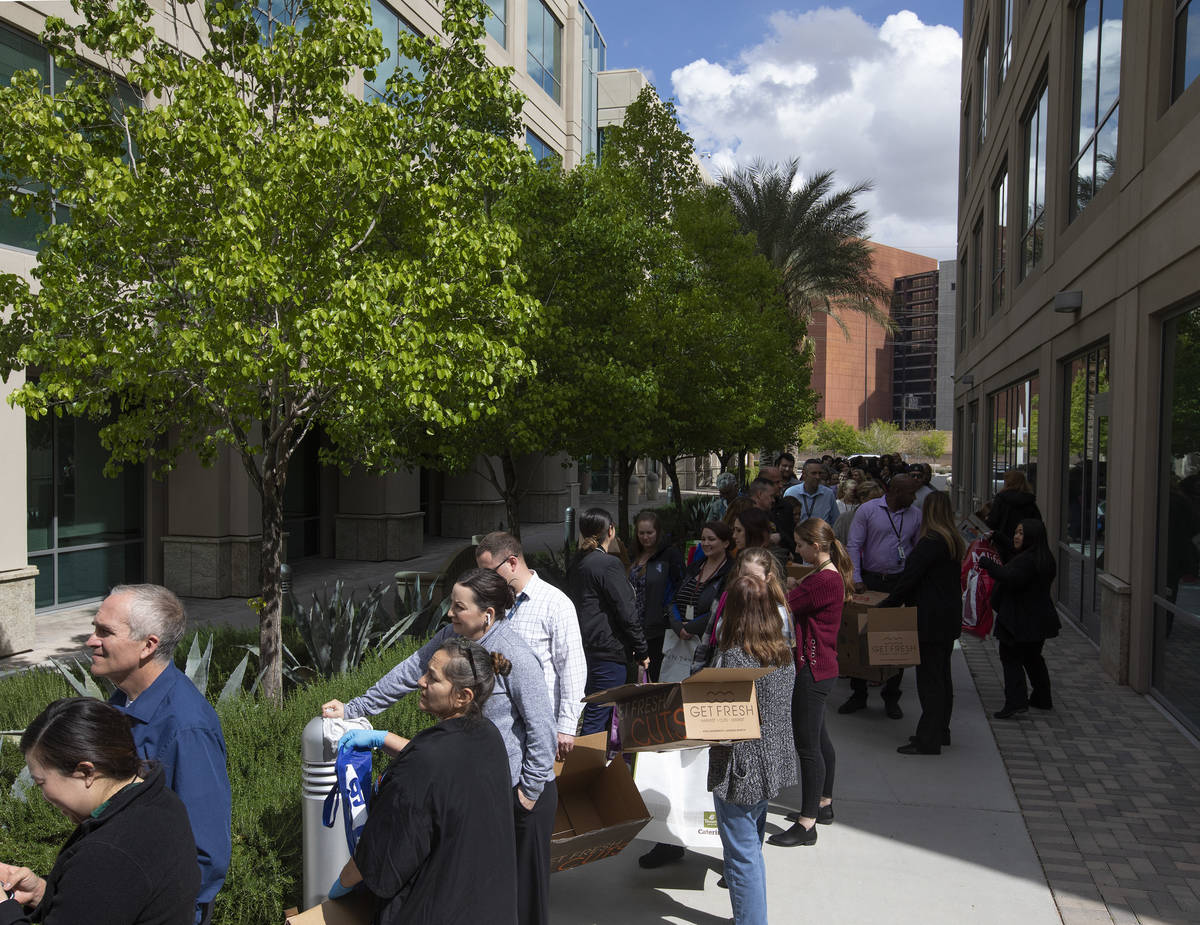 Hundreds line up outside the Las Vegas Metropolitan Police Department headquarters to get produ ...