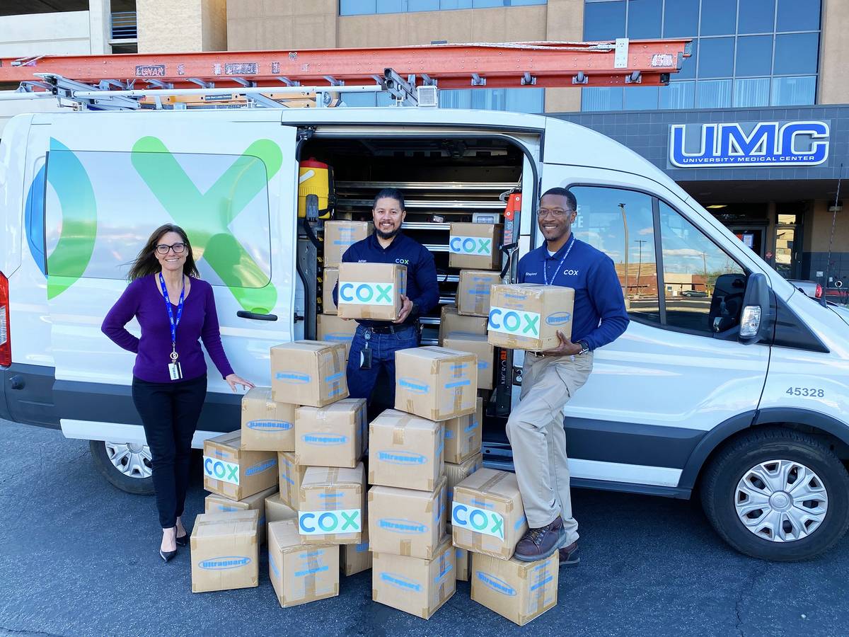 Cox Communications' Field Technicians Adrian Alcala and Rodney Shepherd donate protective shoe ...