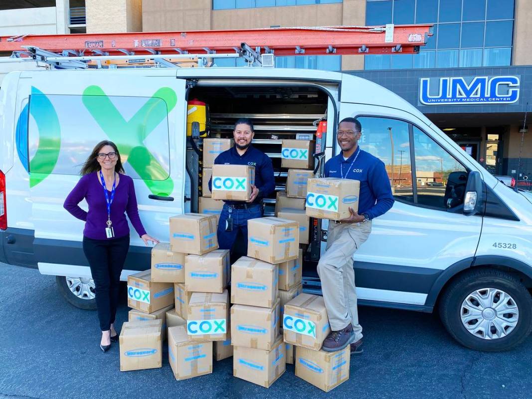 Cox Communications' Field Technicians Adrian Alcala and Rodney Shepherd donate protective shoe ...