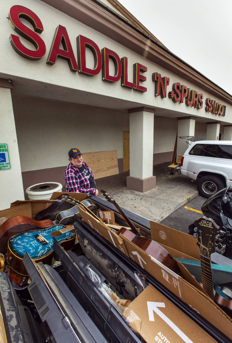 Saddle 'N' Spurs Saloon owner Bobby Kingston beside his packed up his pickup truck with signed ...