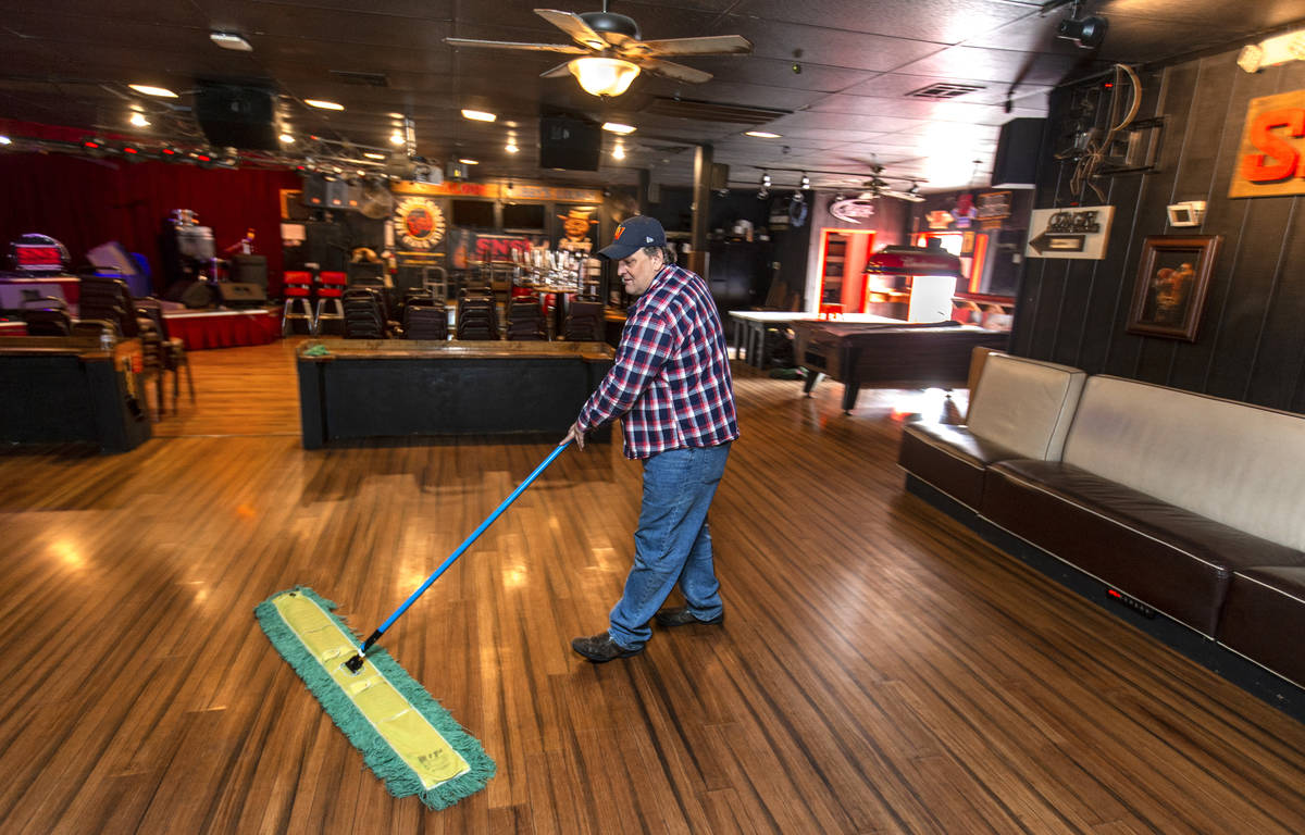 Saddle N Spurs Saloon owner Bobby Kingston continues to clean up his bar, closing for the next ...