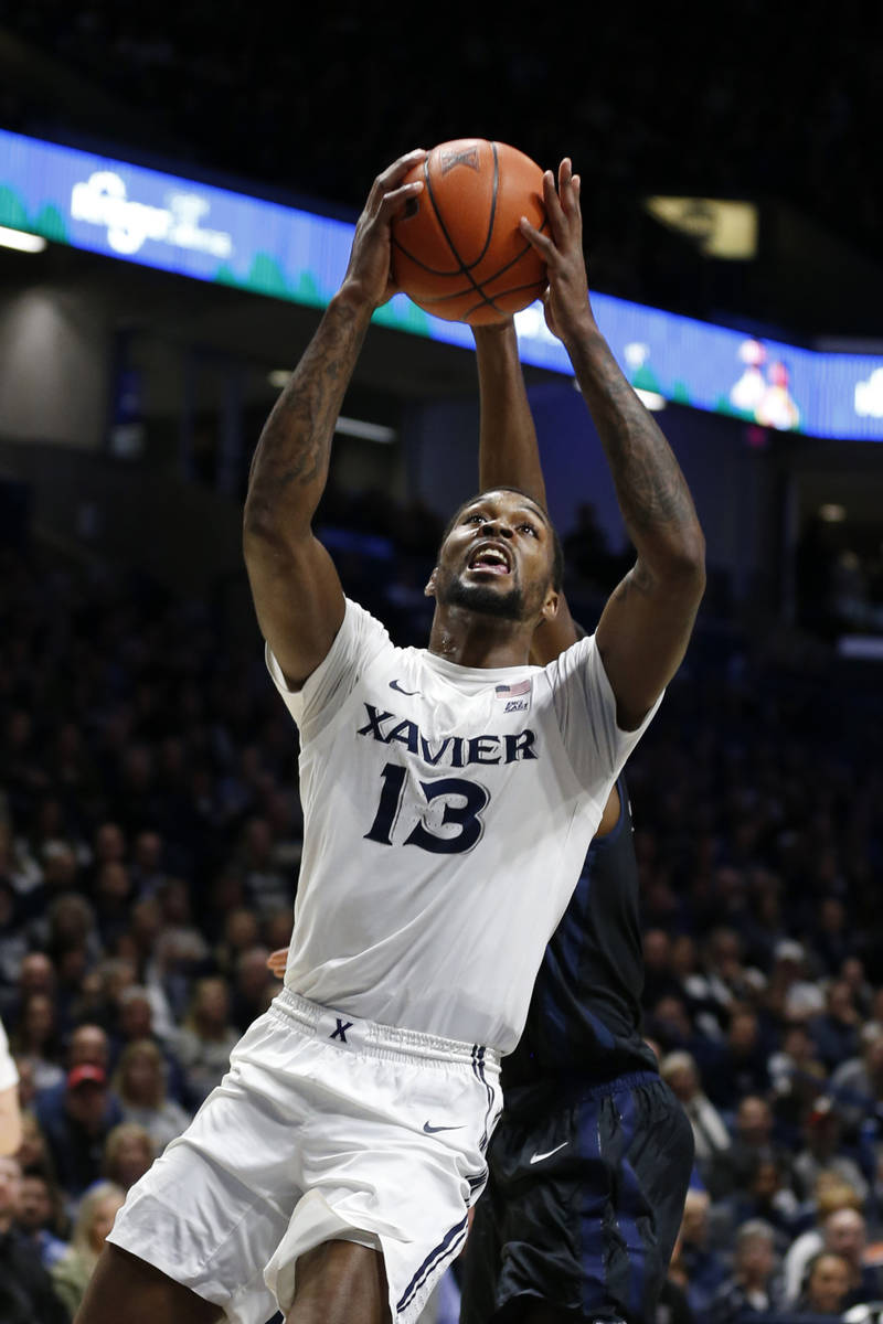 Xavier forward Naji Marshall (13) shoots against Butler during the first half of an NCAA colleg ...