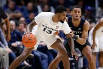Xavier forward Naji Marshall (13) is pressured by Butler guard Aaron Thompson, right, during th ...