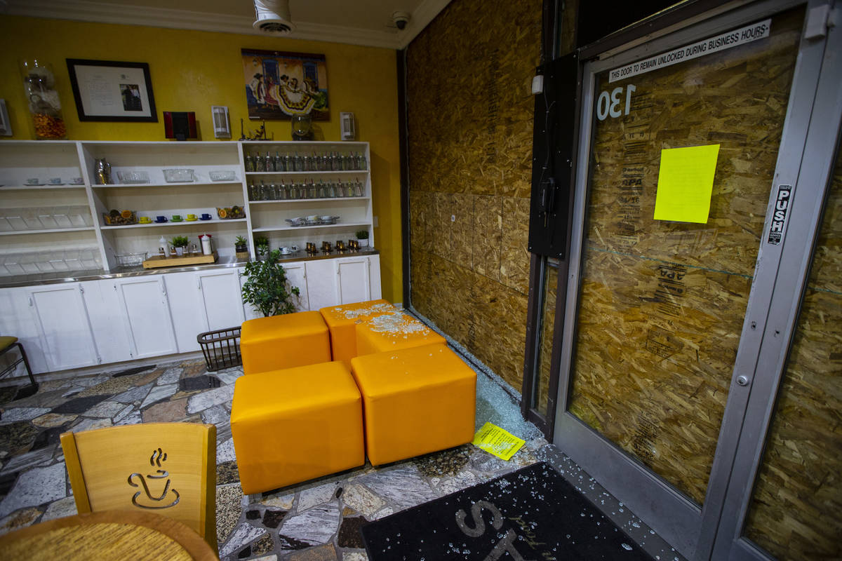 Broken glass windows at Art of Flavors in Las Vegas on Friday, March 20, 2020. (Chase Stevens/L ...