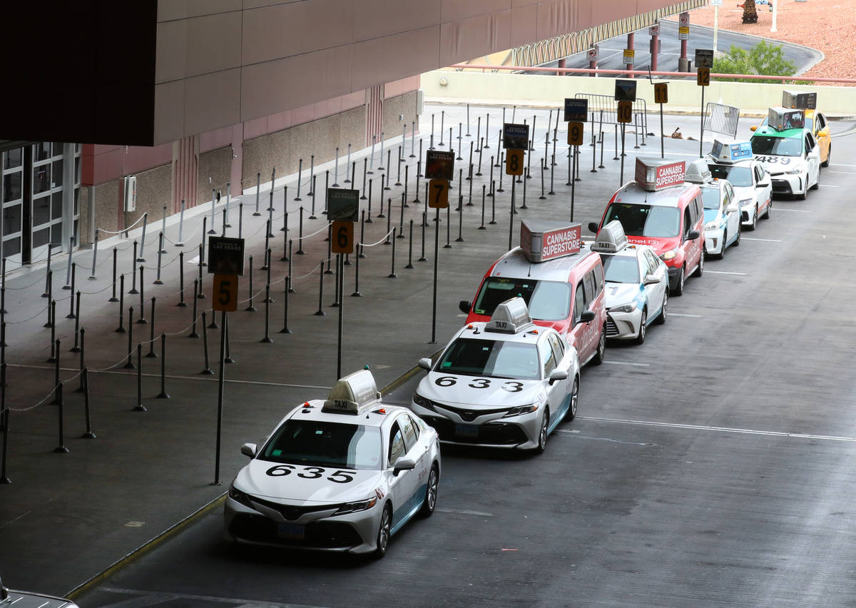 Taxis line up at passengers pick up area at McCarran International Airport on Thursday, March 1 ...