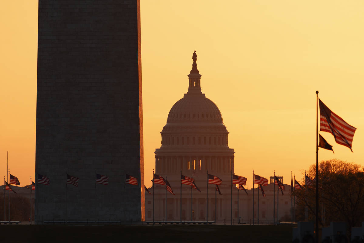 The Washington Monument and the U.S. Capitol are seen in Washington, at sunrise Wednesday, Marc ...