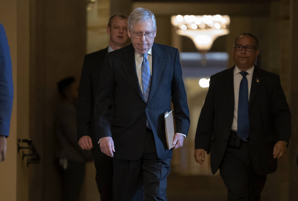 Senate Majority Leader Mitch McConnell, R-Ky., walks to the chamber as lawmakers negotiate on t ...
