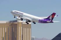 A Hawaiian Airlines jetliner departs from McCarran International Airport in Las Vegas on Wednes ...