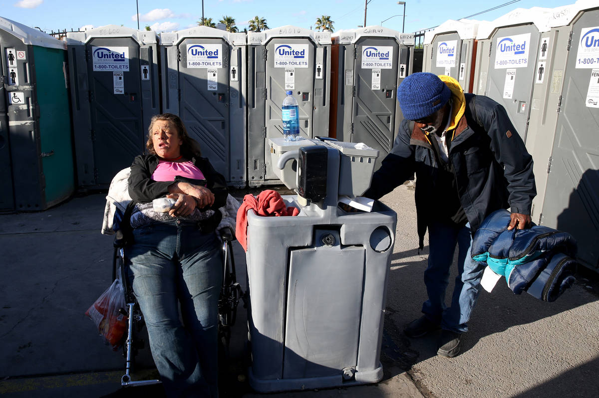 Erica "E.Z." Zehm, 42, at hand washing stations at The Courtyard Homeless Resource Ce ...