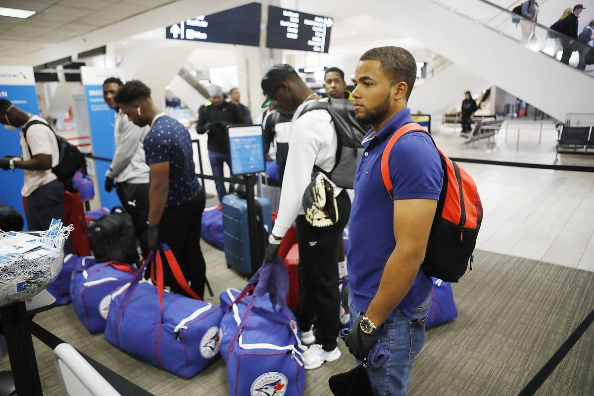 Toronto Blue Jays minor league baseball player Steward Berroa, right, prepares to fly home alon ...