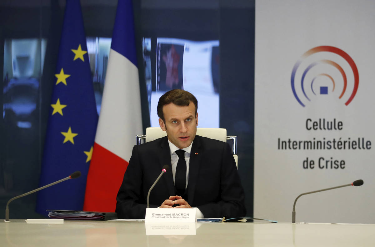 French President Emmanuel Macron attends a meeting at the emergency crisis center of the Interi ...