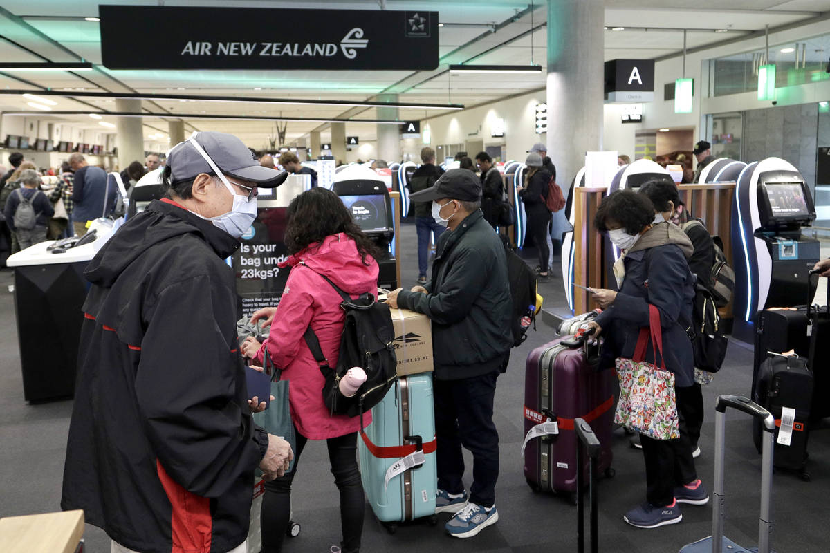 Passengers queue at an Air New Zealand ticketing counter at Christchurch Airport in New Zealand ...