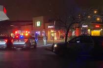 Las Vegas police officers investigate what was reported as a robbery at a convenience store on ...