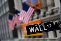 A Wall Street sign is seen in front of the New York Stock Exchange. (AP Photo/Mark Lennihan)