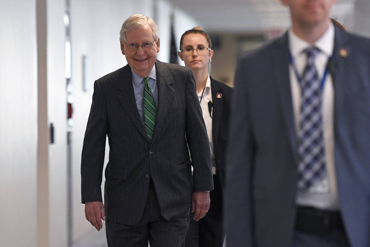 Senate Majority Leader Mitch McConnell of Ky., walk to attend a Republican policy lunch on Capi ...