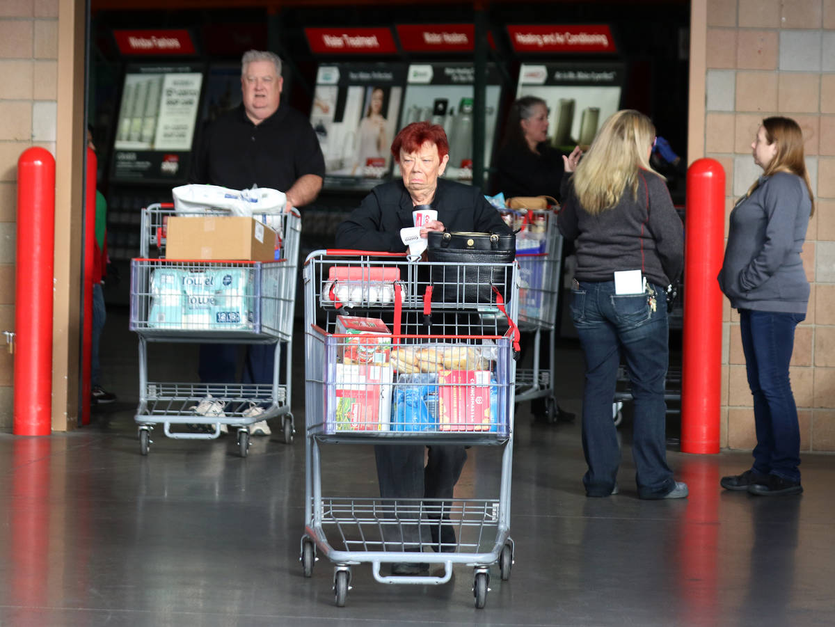 Seniors push their shopping cart after shopping at Costco on Friday, March 20, 2020, in Henders ...
