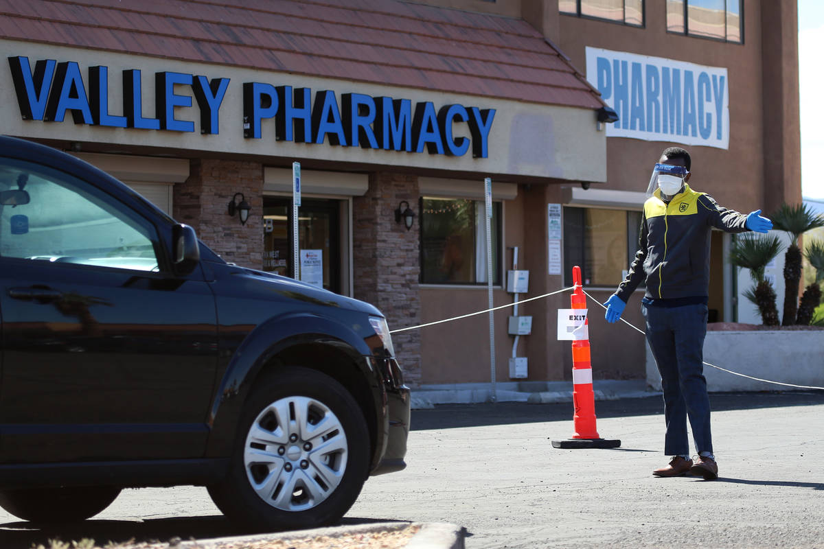 A lab technician directs people at the Sahara Urgent Care & Wellness center in Las Vegas, Tuesd ...
