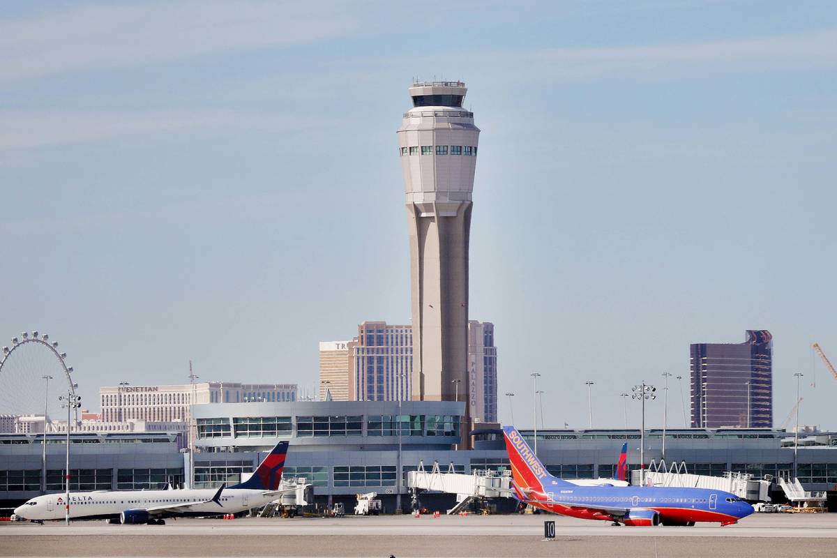 Planes both land and take off at the McCarran International Airport in Las Vegas on Thursday, F ...