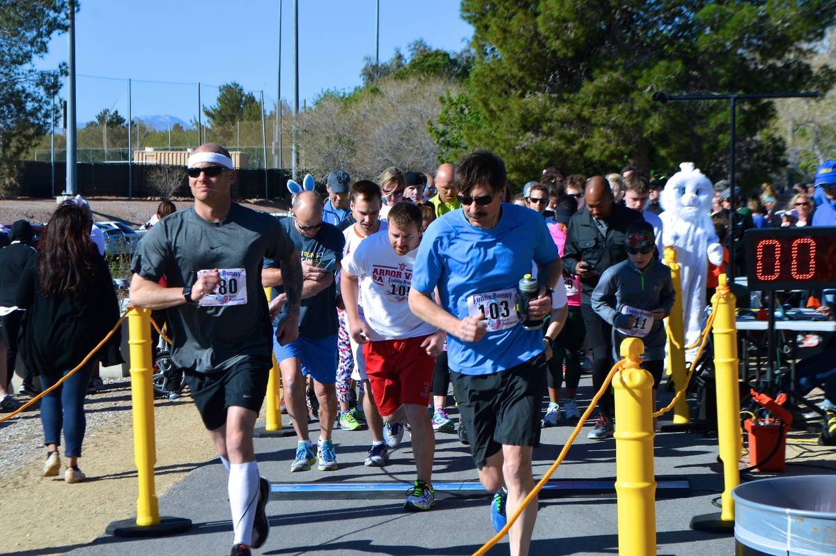 Runners participate in the annual Funny Bunny Race to benefit Friends of Parkinson's in this Ma ...