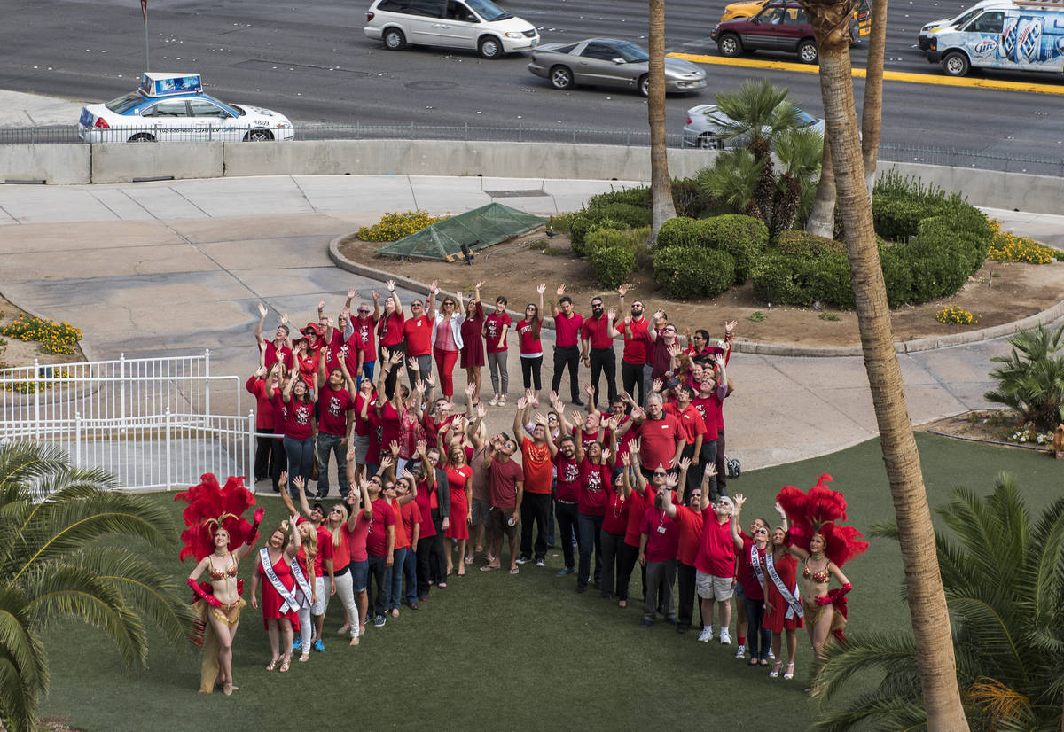 Staff, volunteers, and supporters of Golden Rainbow form a living ribbon in front of the Tropic ...