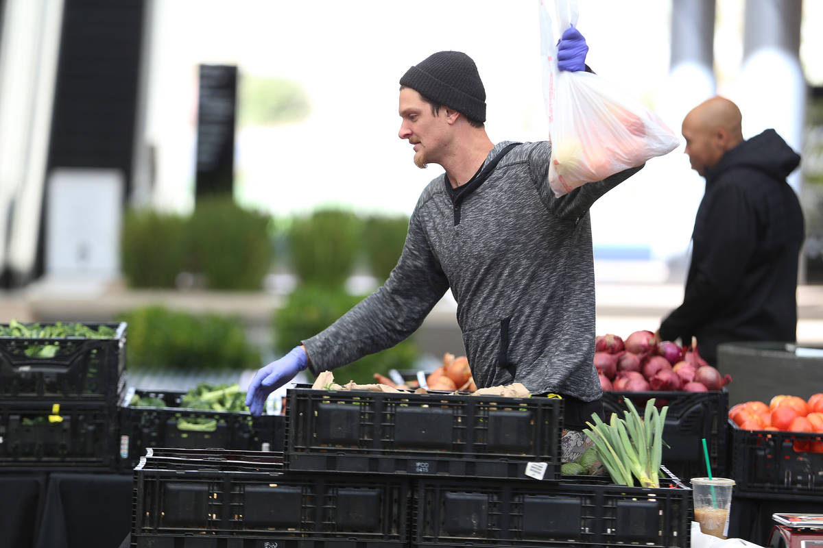 Chris Thompson prepares an order for a customer at the Las Vegas Farmers Market in Downtown Sum ...