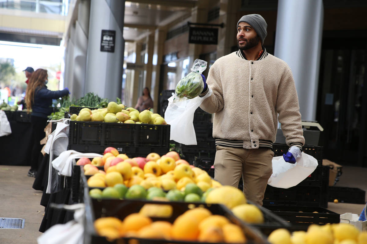 Montel Williams prepares an order for a customer at the Las Vegas Farmers Market in Downtown Su ...