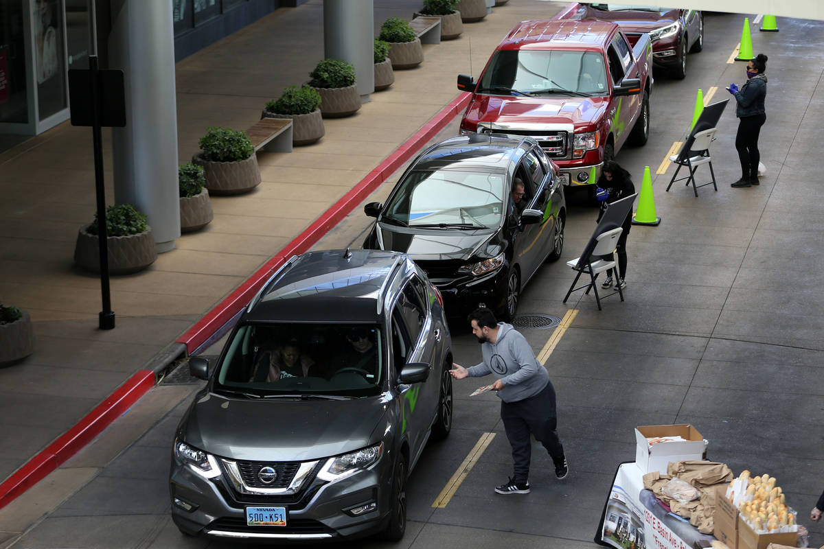 Customers place their orders at the Las Vegas Farmers Market drive-through in Downtown Summerli ...