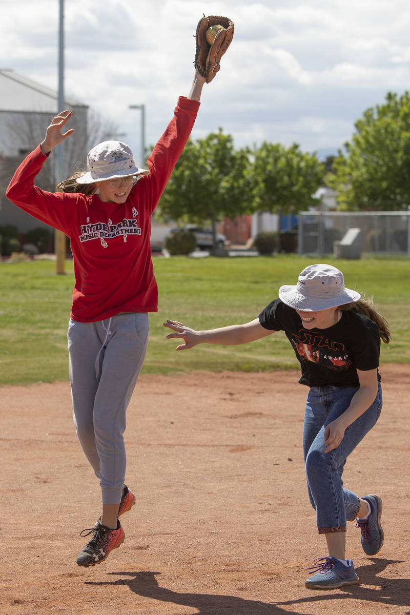 Charlotte Gillette, left, catches the ball as Rosina Gillette, right, ducks to keep from gettin ...