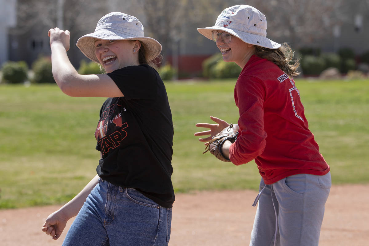 Rosina Gillette, left, runs past after Charlotte Gillette, right, got her out during a game of ...