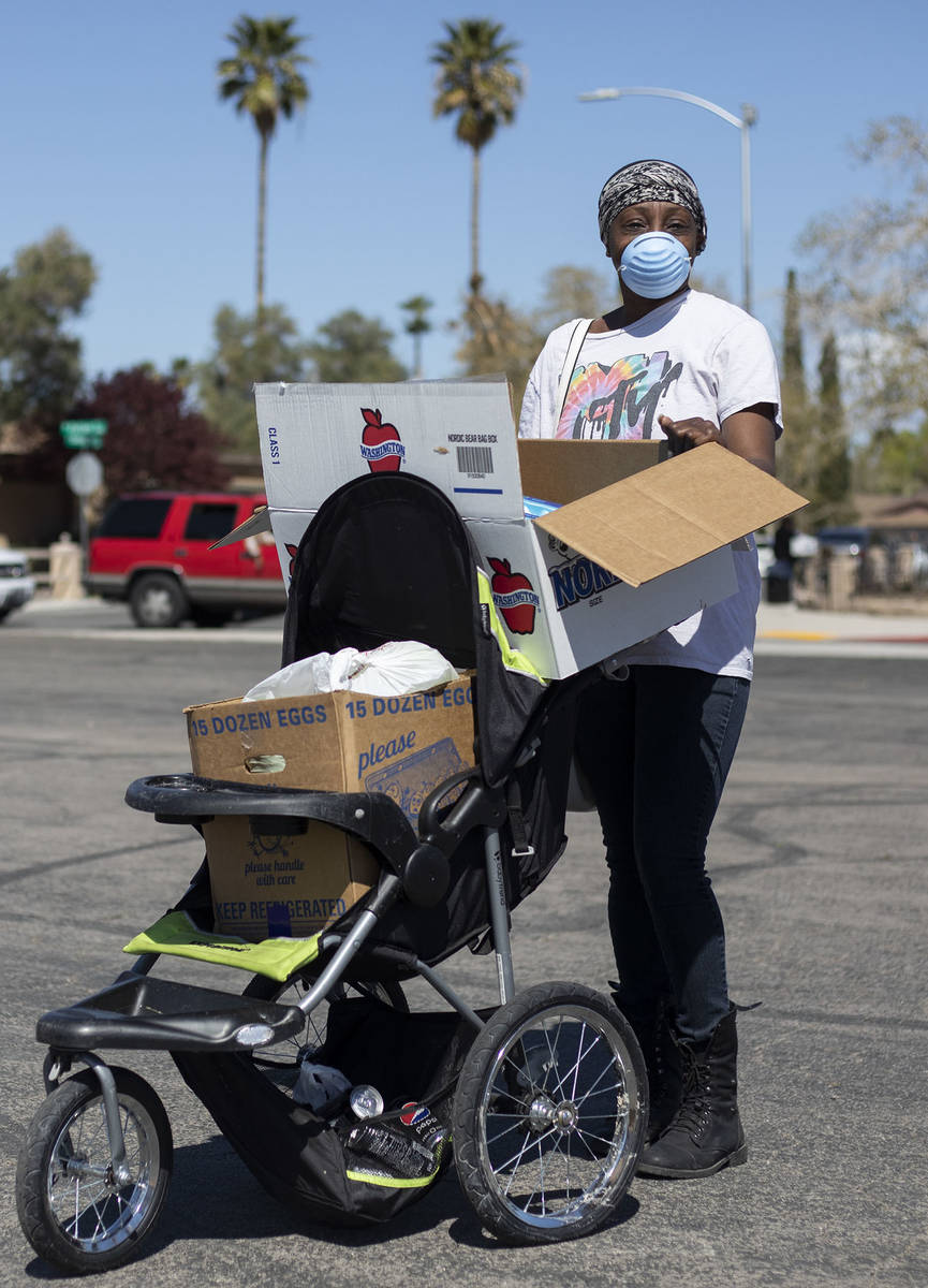 Tiffany Watson, a local who found the food bank on Facebook through The Just One Project, poses ...