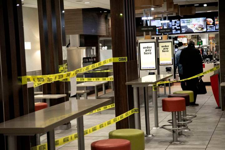 People stand in line for their order at a McDonald's restaurant in the Brooklyn borough of New ...