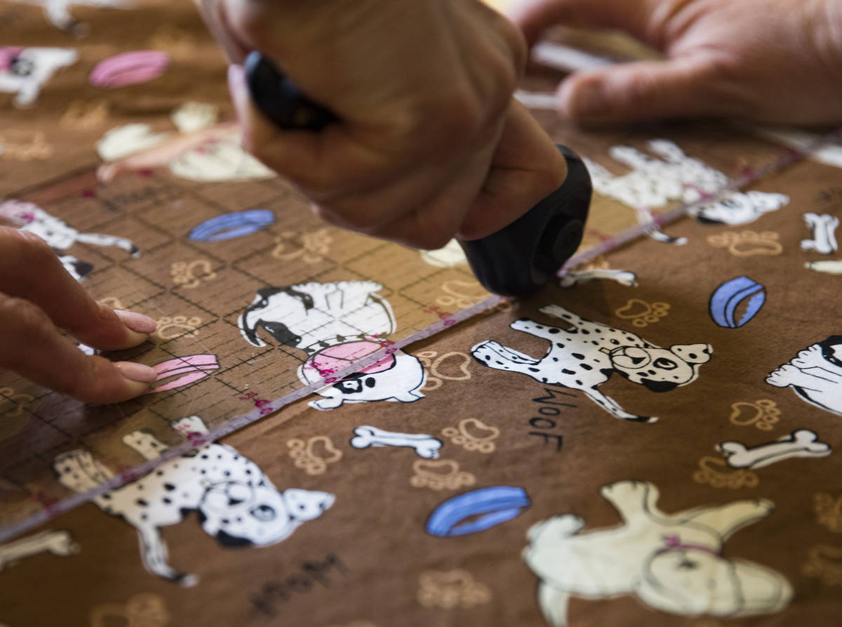 Terri Yannone cuts fabric at her friend Anissa Gustafsonͳ home in Las Vegas, Sunday, Marc ...