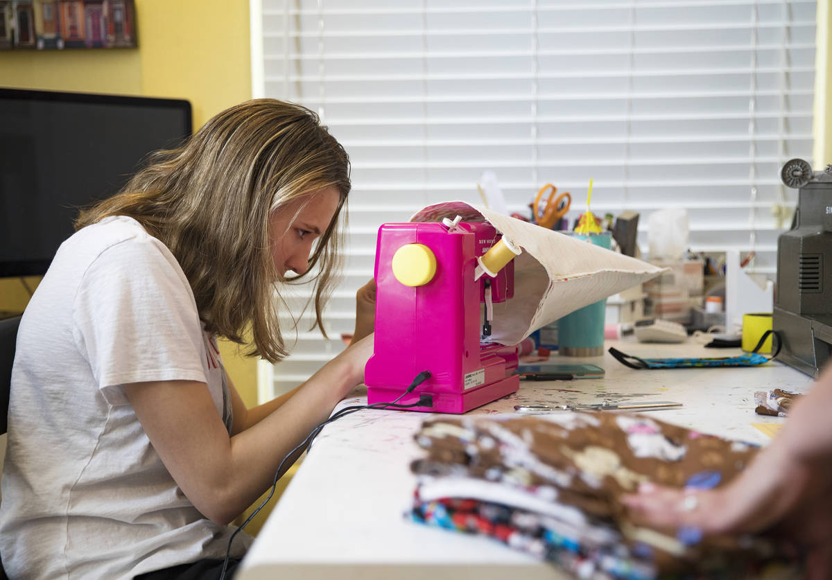 Grace Gustafson, 13, works on a mask at her home in Las Vegas, Sunday, March 22, 2020. She has ...