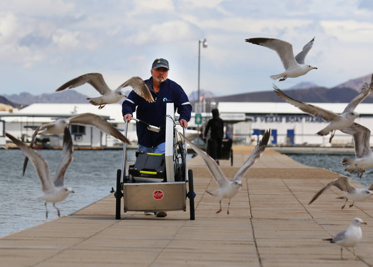 Miguel Matos pushes his belongings that were retrieved from his boat at Lake Mead National Recr ...