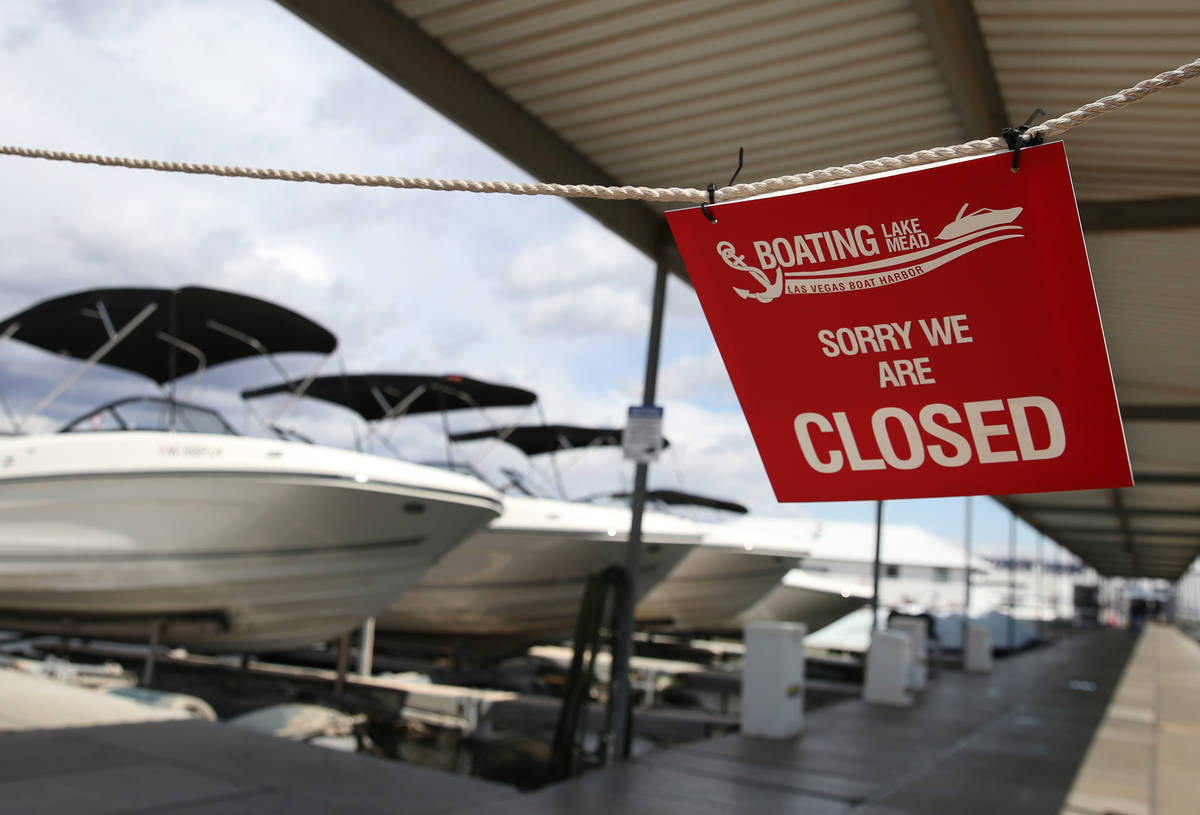 Closed sign is posted at Lake Las Vegas Boat Harbor at Lake Mead National Recreation Area on Mo ...
