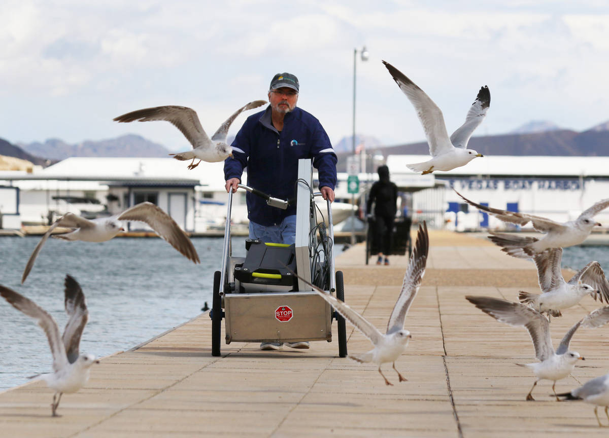 Miguel Matos pushes his belongings that were retrieved from his boat at Lake Mead National Recr ...