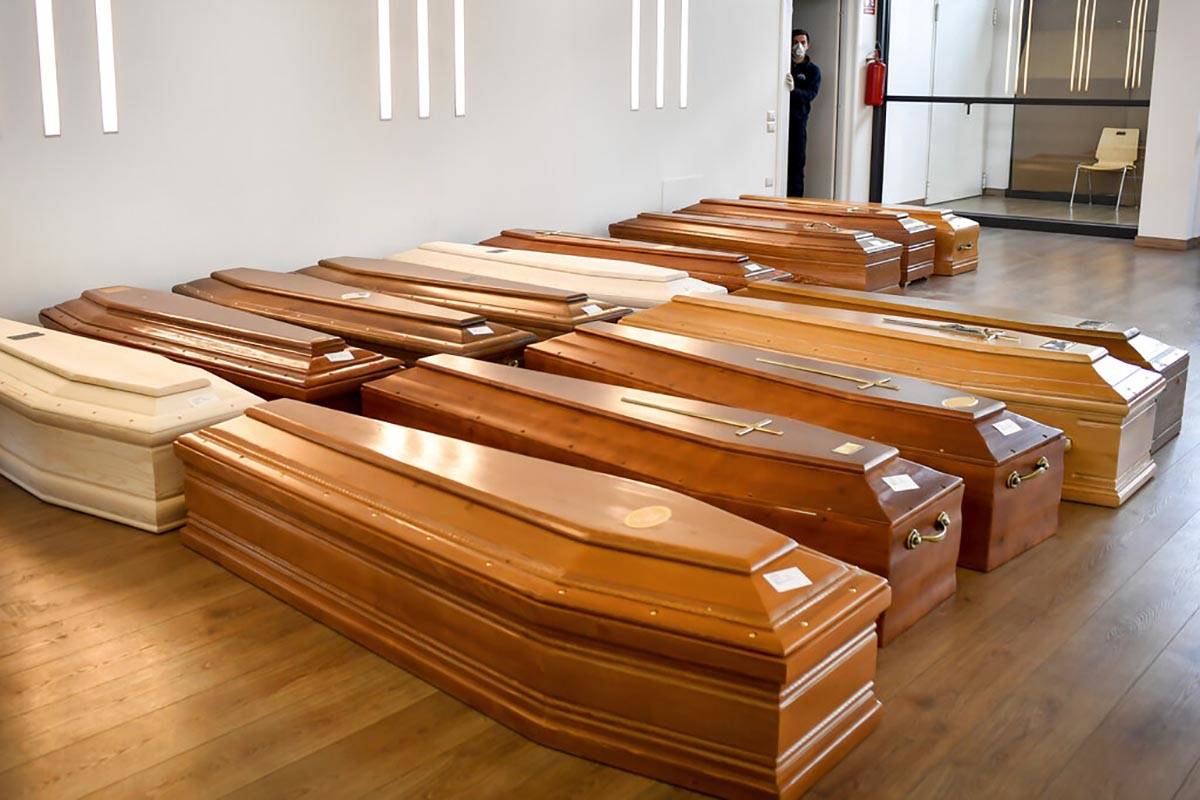 Coffins are lined up on the floor in the Crematorium Temple of Piacenza, Northern Italy, satura ...
