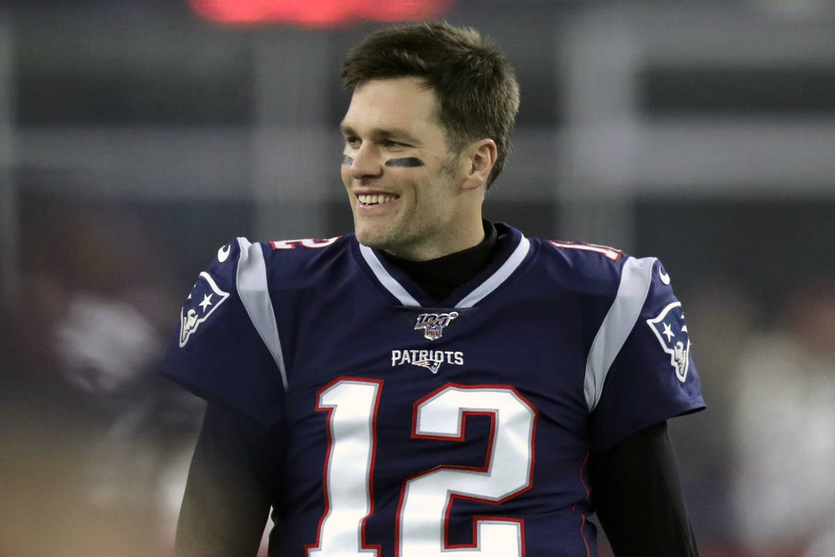 FILE - In this Jan. 4, 2020, file photo, New England Patriots quarterback Tom Brady walks on th ...