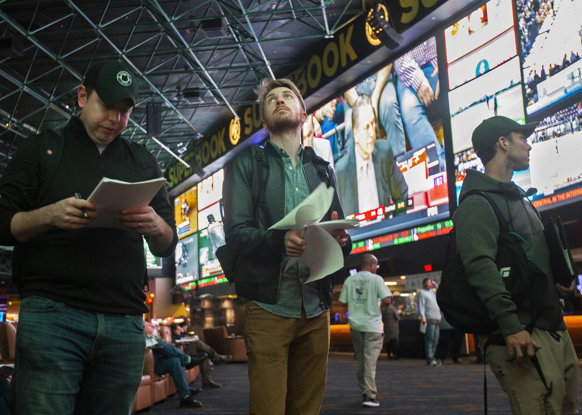 Rufus Peabody, middle, from Boston, Mass., waits in line at Westgate Sportsbook as Super Bowl p ...