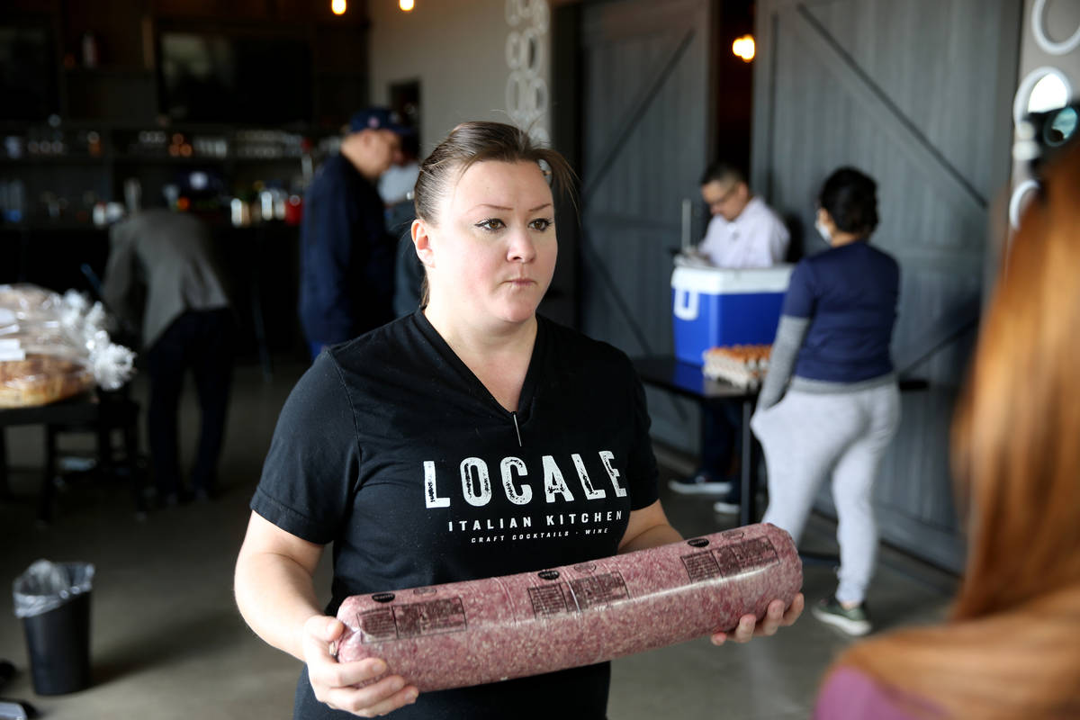 Locale Italian Kitchen chef/partner Nicole Brisson helps a customer shop grocery store-style at ...