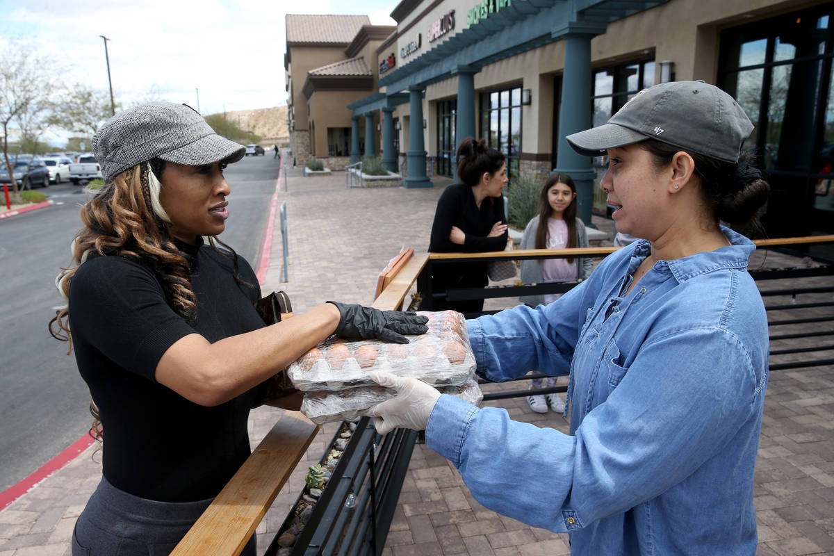 Cindy Braden of Las Vegas, left, shops with server Chantasia Holmes at Locale Italian Kitchen r ...