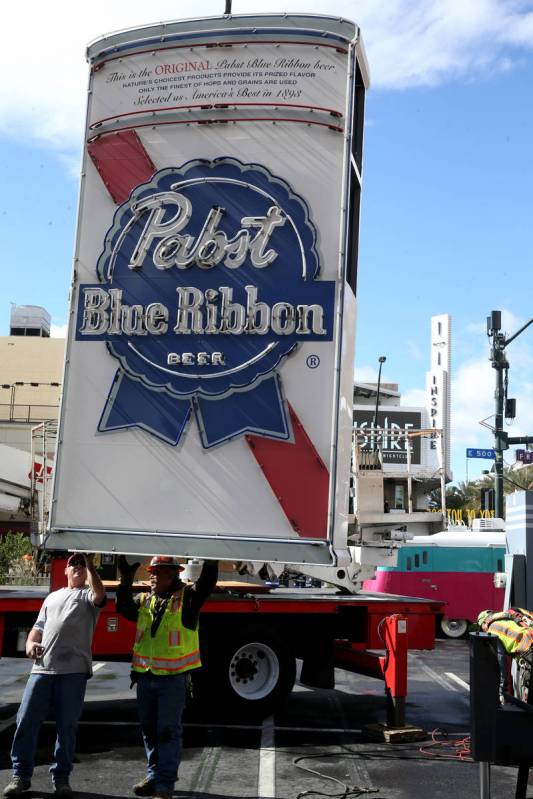 Yesco workers remove the Pabst Blue Ribbon neon sign at Fremont Street and Las Vegas Boulevard ...