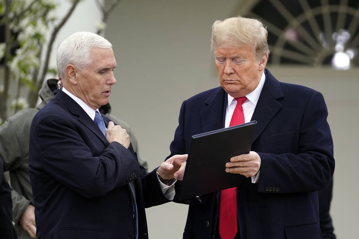 President Donald Trump speaks with Vice President Mike Pence as they arrive for a Fox News Chan ...