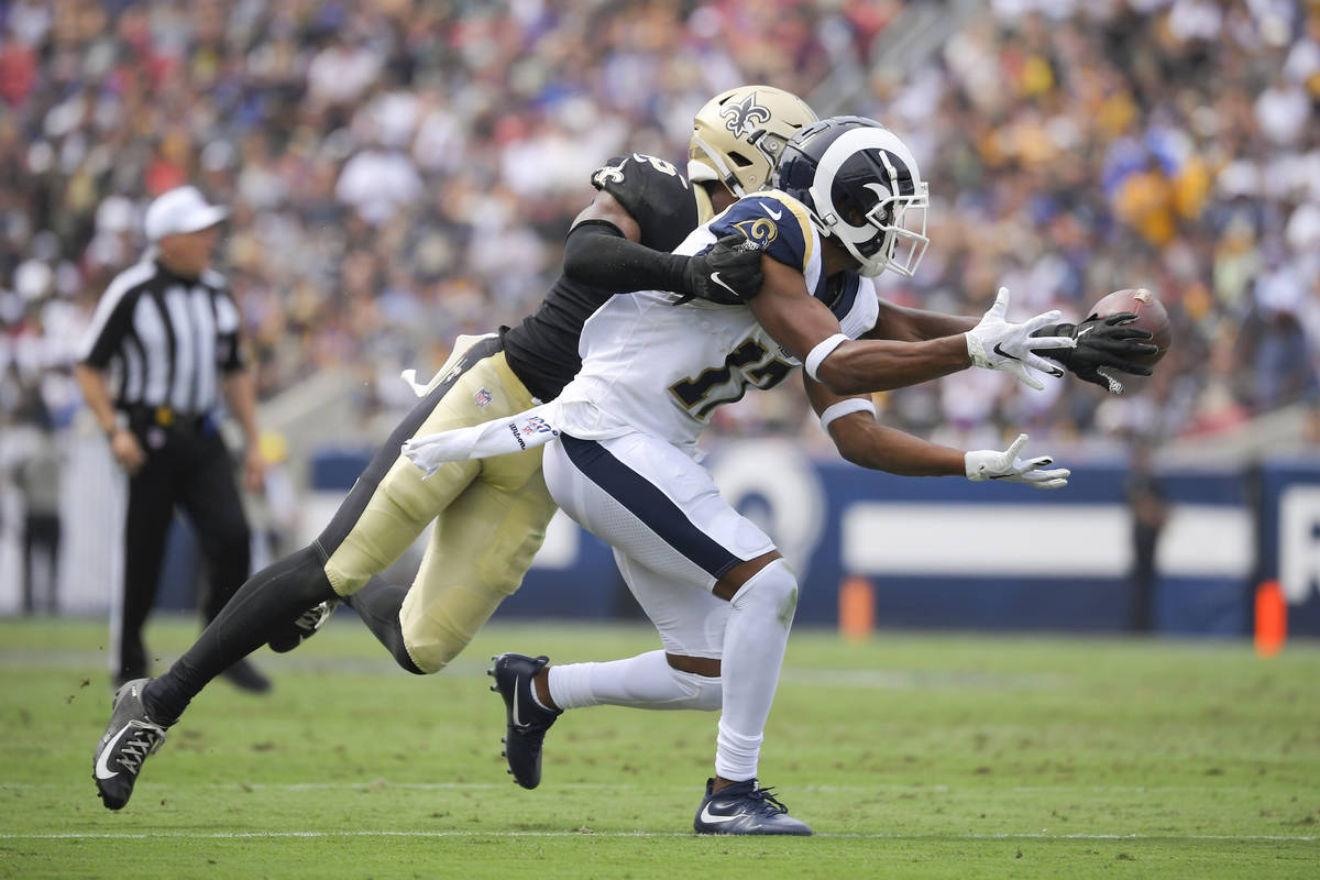 New Orleans Saints cornerback Eli Apple, left, breaks up a pass intended for Los Angeles Rams w ...