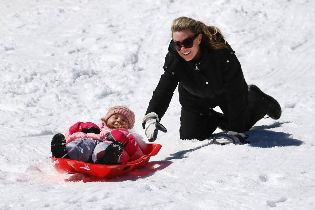 Blake Myers, 4, gets help from her mother, Jodi, as she sleds down a hill at Lee Canyon on Tues ...