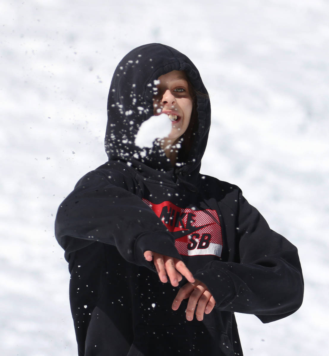 Chloe Solano, 10, of Las Vegas throws a snowball as she plays with her family at Lee Canyon on ...