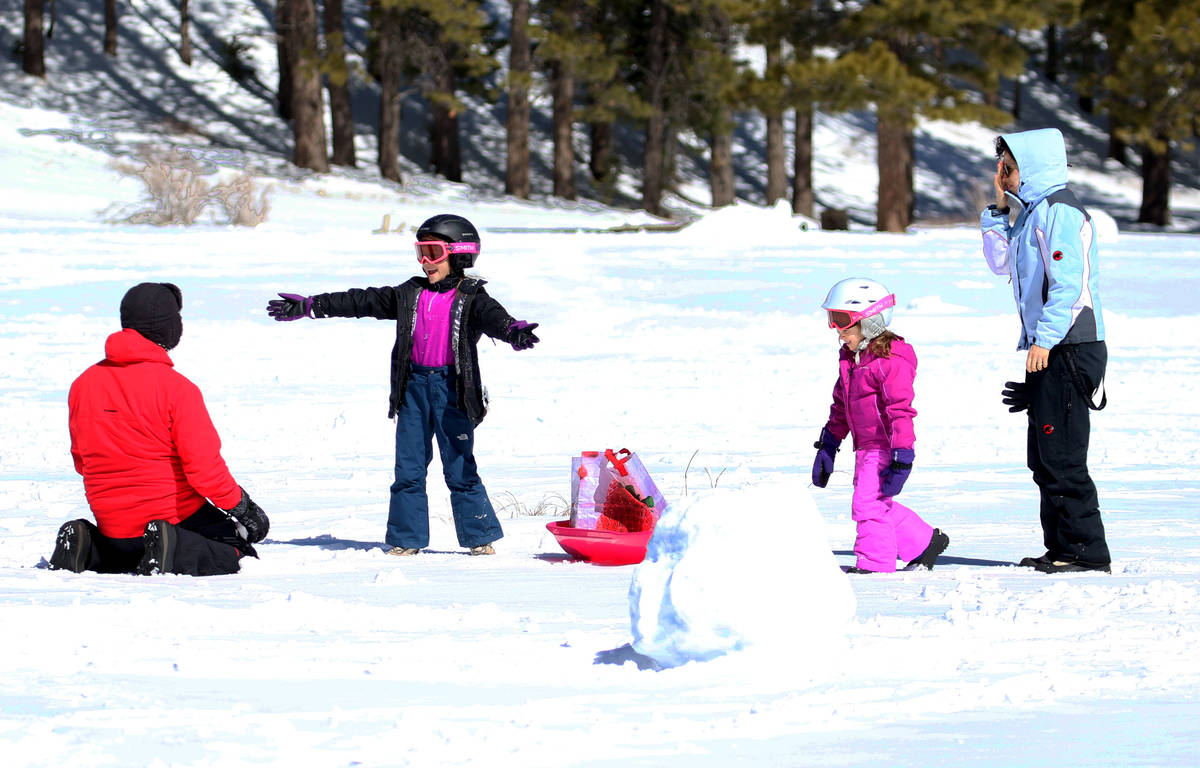 Alan Ravizza of Las Vegas, left, plays with his children Ambra, 7 and Mayra, 5, and his wife, B ...