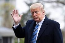 President Donald Trump waves as he walks from Marine One as he returns to the White House, Satu ...